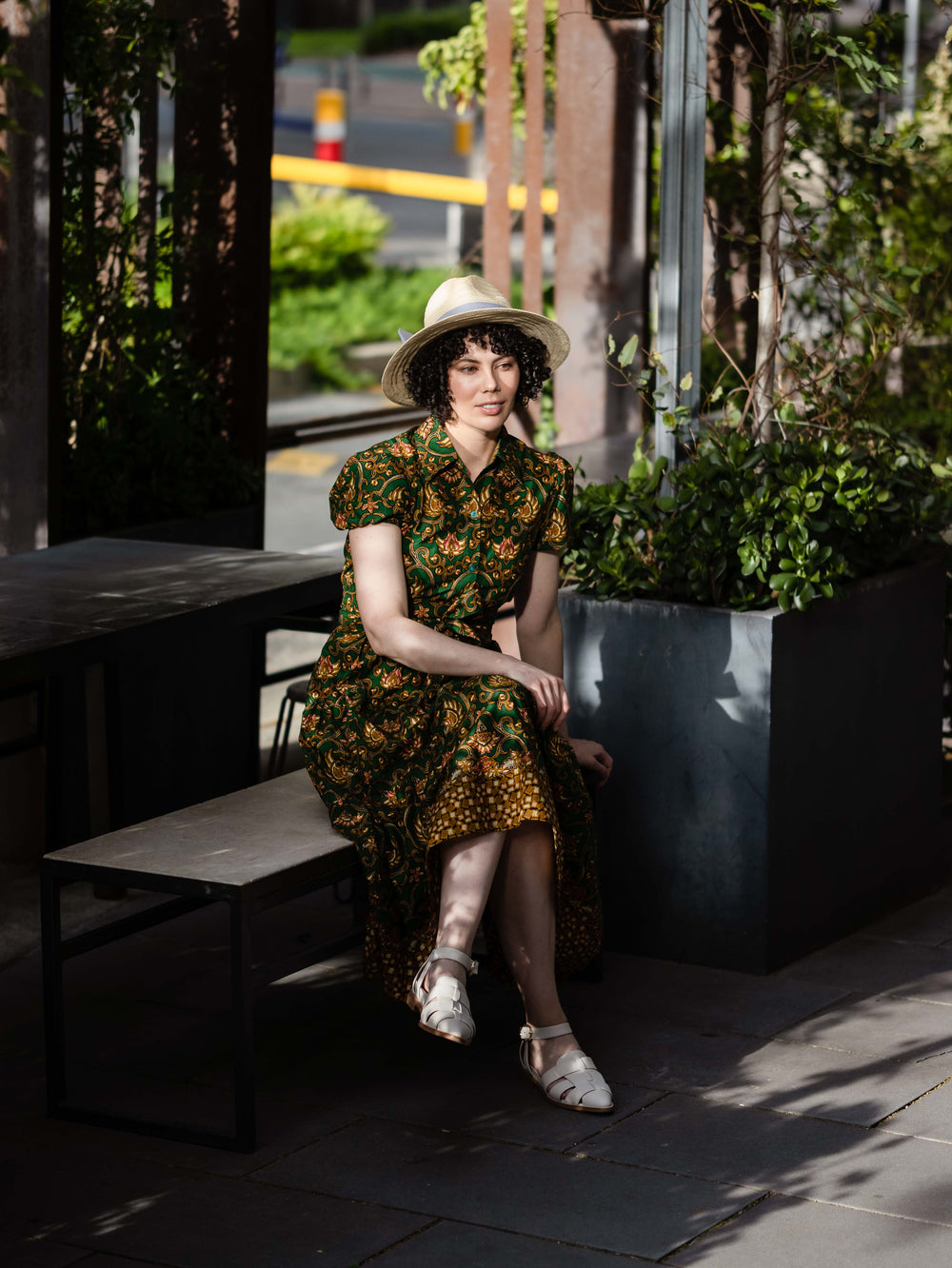 Batik Midi Dress Aulia sitting outside